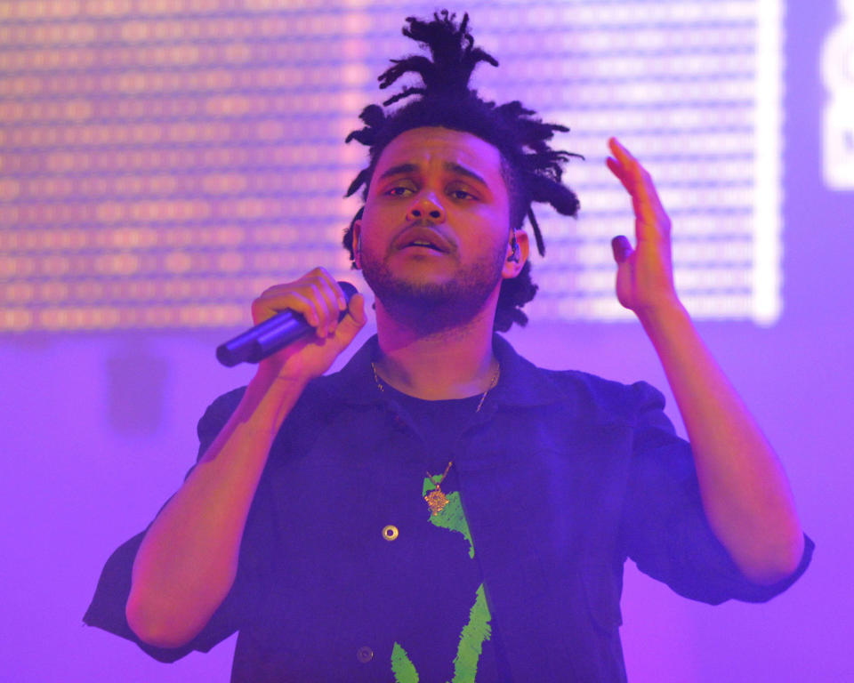 FILE - This Oct. 7, 2013 file photo shows Canadian recording artist Abel Tesfaye performing in concert as The Weeknd at Radio City Music Hall in New York. The Weeknd is part of a breed of newer and lesser known acts who are able to sell out top venues, even if they aren’t selling millions of albums and singles, or dominating with chart-topping tracks and radio airplay. (Photo by Greg Allen/Invision/AP)