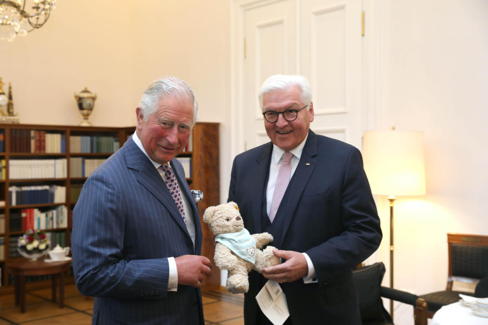 The Prince of Wales is handed a soft toy for his new grandson by German President Frank-Walter Steinmeier during a meeting in Berlin [Photo: PA]