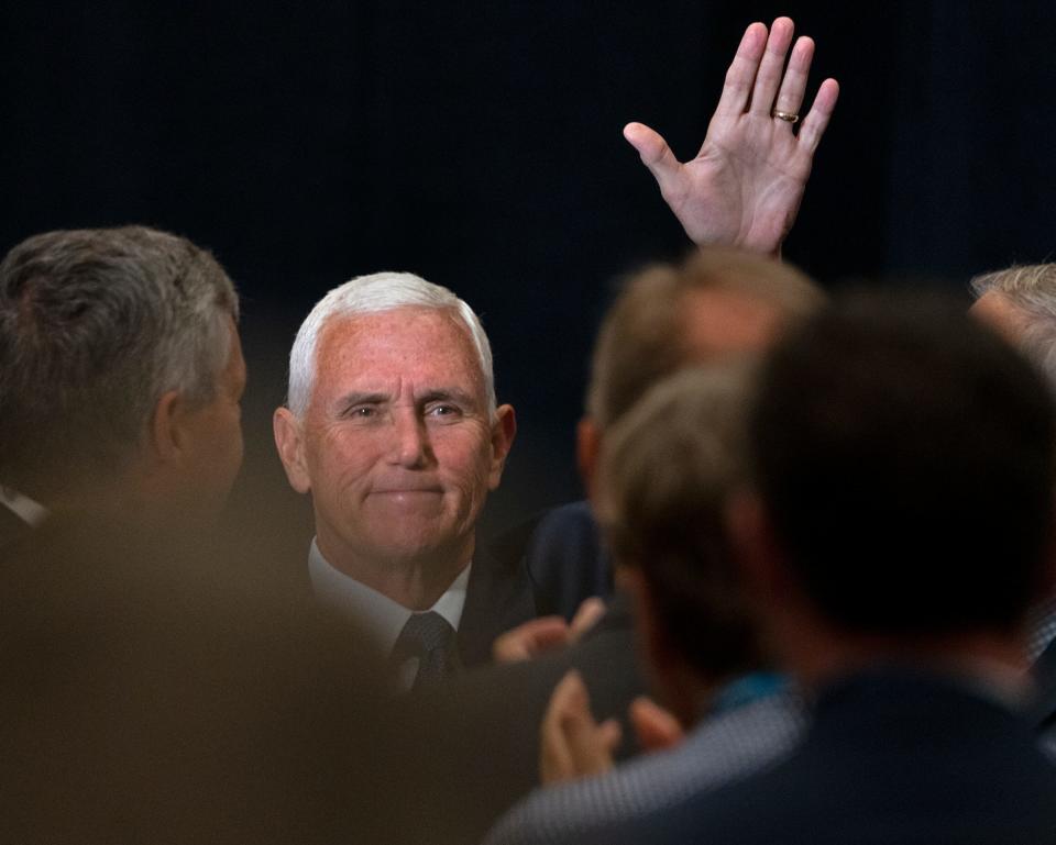 Former Vice President Mike Pence waves over the crowd as he enters the room before speaking during the NCSL Legislative Summit at the Indiana Convention Center, Wednesday, Aug. 16, 2023 in Indianapolis.