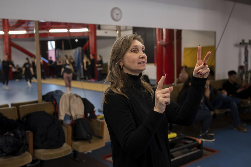 Ukrainian refugee circus trainer Svetlana Momot giving instructions to her students in a training room in Budapest, Hungary, Monday, Feb. 13, 2023. More than 100 Ukrainian refugee circus students, between the ages of 5 and 20, found a home with the Capital Circus of Budapest after escaping the embattled cities of Kharkiv and Kyiv amid Russian bombings. (AP Photo/Denes Erdos)