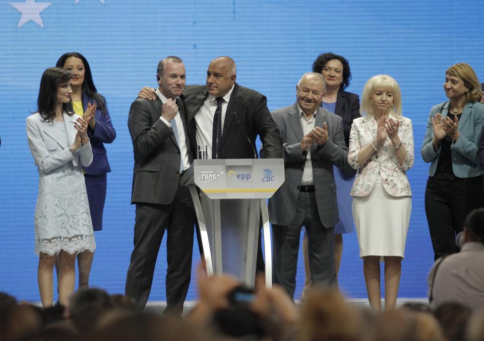Germany's Manfred Weber of the European People's Party, third left, is hugged by Bulgarian PM Borissov during the ruling party GERB's rally in Sofia, Bulgaria, Sunday, May 19, 2019. The rally comes days before more than 400 million Europeans from 28 countries will head to the polls to choose lawmakers to represent them at the European Parliament for the next five years. (AP Photo/Valentina Petrova)