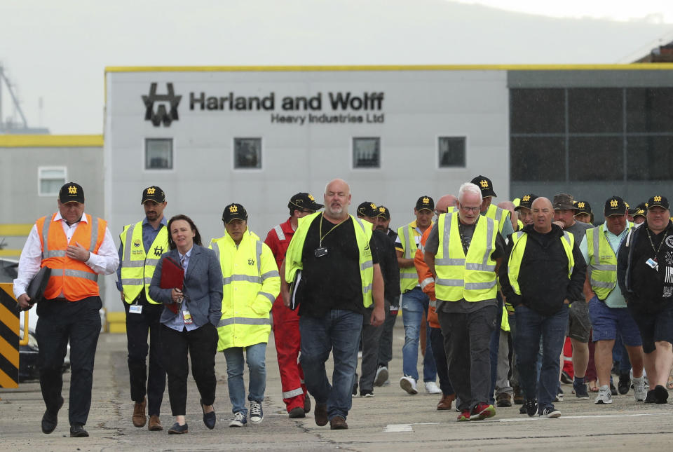 Harland and Wolff shipyard workers emerge after voting to continue their occupation of the shipyard, in Belfast, Northern Ireland, Monday Aug. 5, 2019. Harland and Wolff, which is one of Northern Ireland's most historic brands with credits including for building the RMS Titanic, is facing closure after its trouble-hit Norwegian parent company Dolphin Drilling failed to find a buyer. (Liam McBurney/PA via AP)