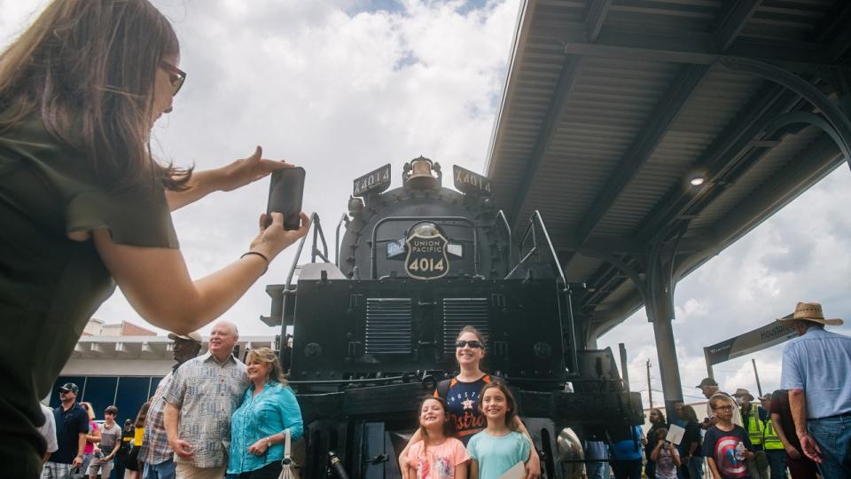 <div>A family stands together for a picture in front of the Big Boy No. 4014 locomotive on August 17, 2021 in Houston, Texas.(Photo by Brandon Bell/Getty Images)</div>