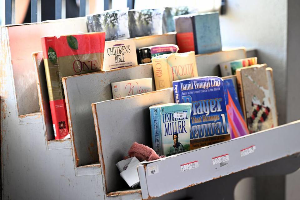 The open porch at Turning Points, a social services hub for people facing homelessness, has a bookshelf for clients as they wait for appointments. Gov. Ron DeSantis recently signed into law HB 1365, banning public sleeping and camping.