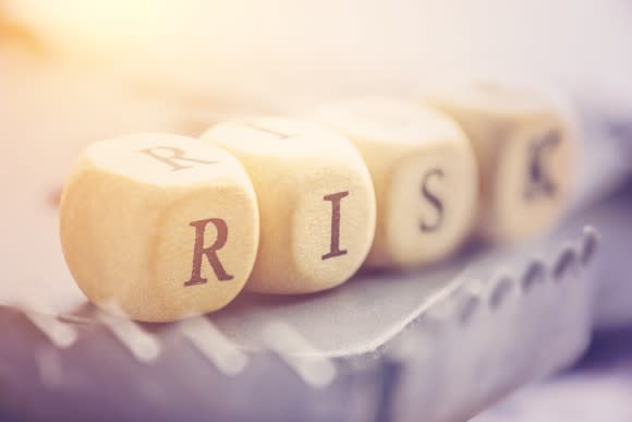 The word "risk" spelled out using dice.