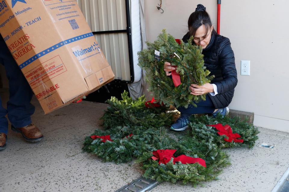 Rachel Tribble with the Apalachee chapter of the Daughters of the American Revolution works with other volunteers to organize 1,500 Wreaths Across America wreaths at Mars Hill Baptist Church in Watkinsville, Ga., on Tuesday, Dec. 12, 2023. Wreaths Across America works to place wreaths on graves in military cemeteries all over the country.