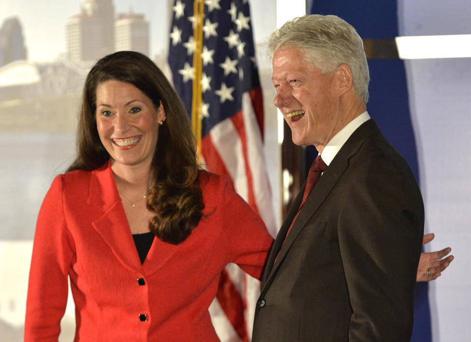 Democratic Senate challenger Alison Lundergan Grimes left, speaks with former Presidet Bill Clinton as they are introduced at a fundraiser at the Galt House Hotel, Tuesday, Feb. 25, 2014, in Louisville, Ky. (AP Photo/Timothy D. Easley)