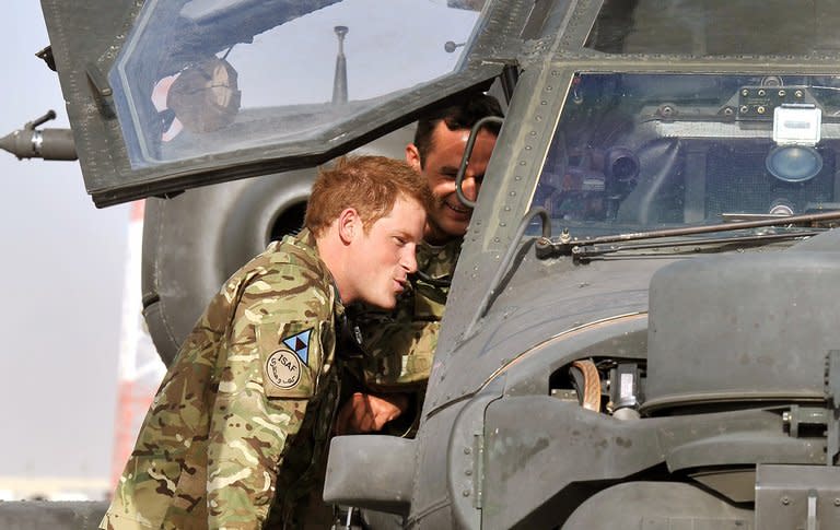 Prince Harry examines the interior of an Apache helicopter at Camp Bastion in Helmand Province, on September 7, 2012