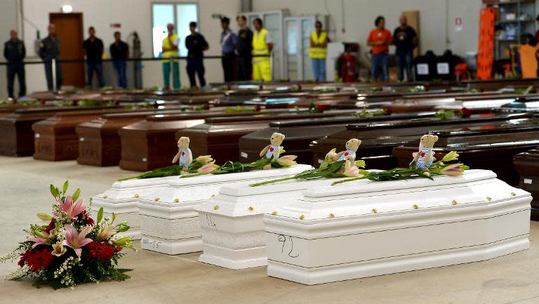 Coffins of victims including children in a hangar at Lampedusa airport on October 5, 2013