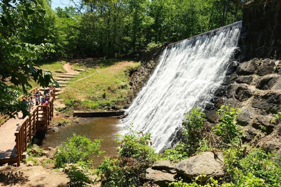 Water flows over a dam on Lake Placid at Paris Mountain State Park. 