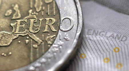 A two Euro coin is pictured next to an English ten Pound note in an illustration taken March 16, 2016. REUTERS/Phil Noble/Illustration