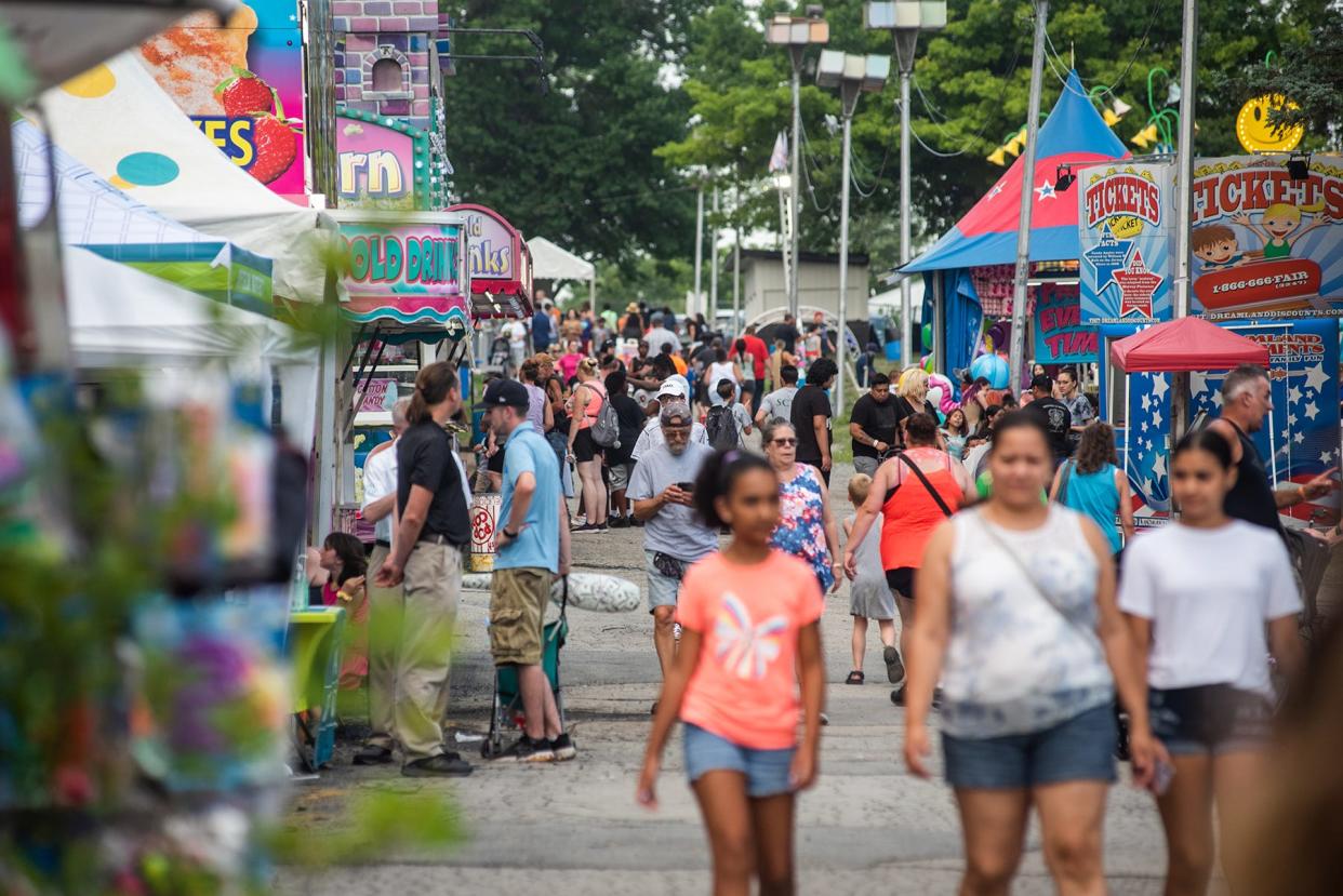 Revelers walk the midway during opening day of the Orange County Fair in the town of Wallkill, NY on Thursday, July 15, 2021.