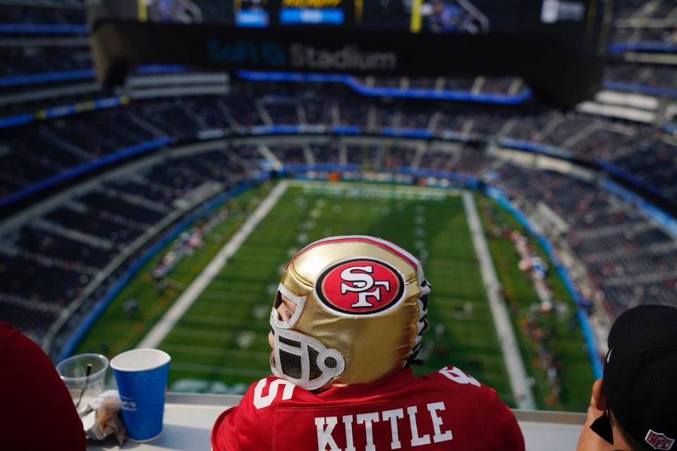 A San Francisco 49ers fans takes in a game at SoFi Stadium.