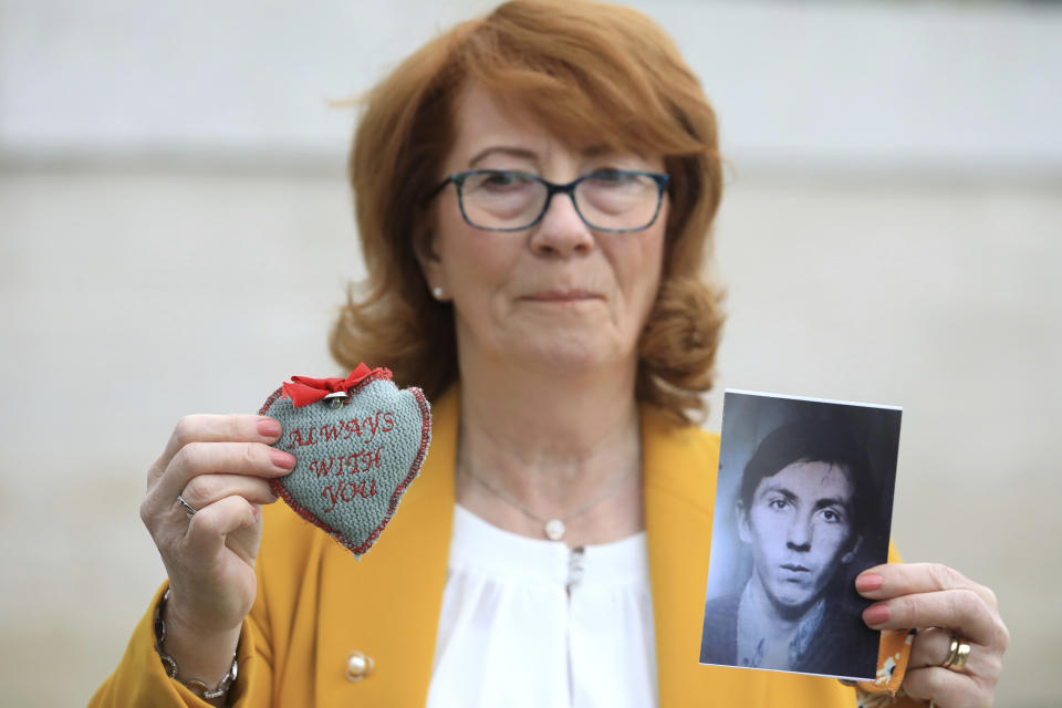 Rita Bonner holds a photograph of her brother John Laverty who was shot in Ballymurphy, ahead of the inquest into the shooting, in Belfast, Northern Ireland, Tuesday May 11, 2021. The findings of the inquest into the deaths of 10 people during an army operation in August 1971 is due to be published on Tuesday. (AP Photo/Peter Morrison)