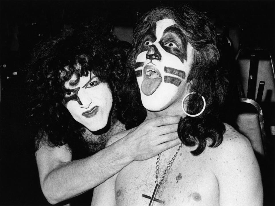 Stanley pretends to choke Peter Criss during the Alive! sessions. Criss would later leave the band and complain of being mistreated by Stanley and Simmons. (Photo by Fin Costello/Redferns)