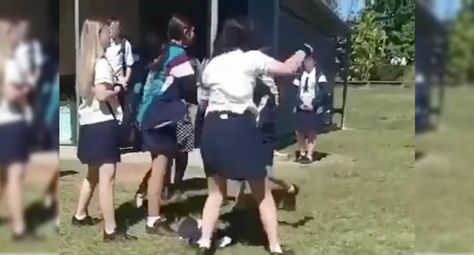 Video shows three girls around a year 7 student who was involved in a fight at Calamvale Community College, Brisbane.