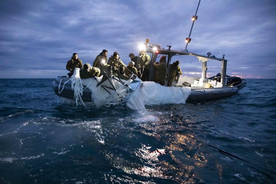 Sailors assigned to Explosive Ordnance Disposal Group 2 recover a high altitude balloon off the coast of Myrtle Beach, South Carolina, Feb. 5, 2023. The suspected Chinese spy balloon was shot down on Saturday, Feb. 4.  / Credit: U.S. Navy Photo