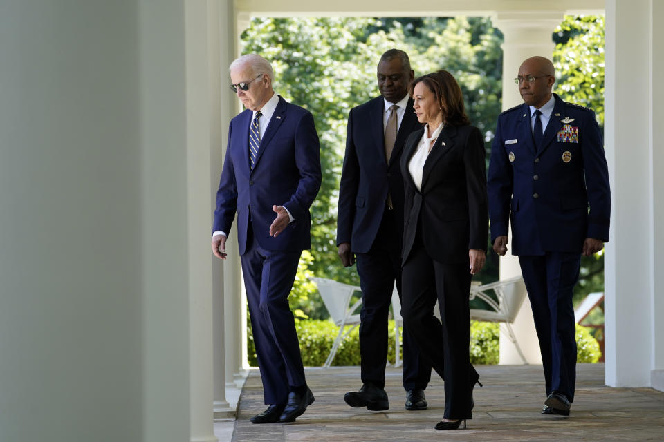President Joe Biden arrives with Defense Secretary Lloyd Austin, Vice President Kamala Harris and U.S Air Force Chief of Staff Gen. CQ Brown Jr., for an event to announce Brown to serve as the next Chairman of the Joint Chiefs of Staff in the Rose Garden of the White House, Thursday, May 25, 2023, in Washington. (AP Photo/Evan Vucci)