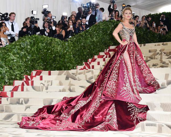 <p>George Pimentel / Getty Images</p> Blake Lively at the 2018 Met Gala in a custom Atelier Versace gown and Lorraine Schwartz halo headpiece