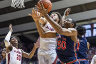 Alabama forward Alex Reese (3) and Auburn center Austin Wiley (50) chase a rebound during the first half of an NCAA college basketball game, Wednesday, Jan. 15, 2020, in Tuscaloosa, Ala. (AP Photo/Vasha Hunt)