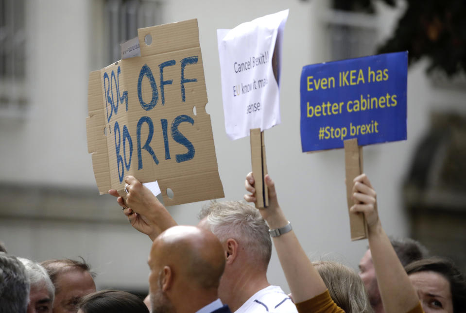 Pro-EU supporters hold signs during a demonstration outside a meeting between British Prime Minister Boris Johnson and Luxembourg's Prime Minister Xavier Bettel at the prime ministers office in Luxembourg, Monday, Sept. 16, 2019. (AP Photo/Olivier Matthys)