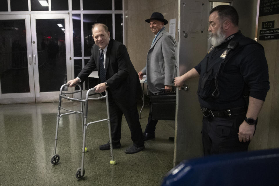 A court officer holds the door as Harvey Weinstein, left, leaves the courtroom with his attorney Arthur Aidala at the end of the first day of his trial on rape and sexual assault charges, Wednesday, Jan. 22, 2020, in New York. (AP Photo/Mary Altaffer)