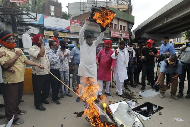 Indians burn products made in China (Rajesh Kumar Singh/AP)