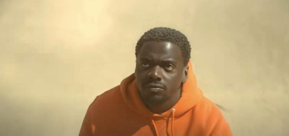 Daniel Kaluuya gazes upward while wearing a hooded sweatshirt in a scene