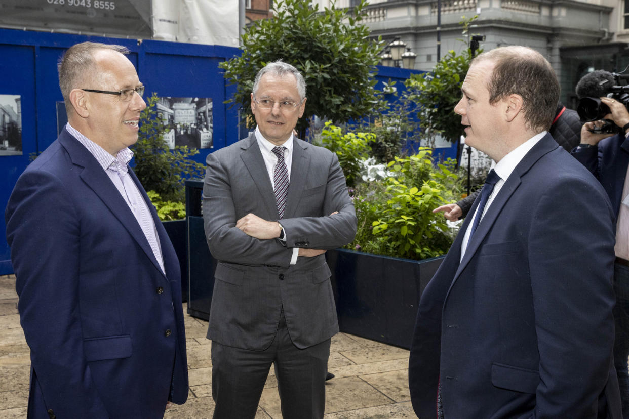 (L to R) Agio chief revenue officer Garvin McKee, Invest NI chief executive Kevin Holland and Economy Minister Gordon Lyons outside Invest NI in Belfast (Liam McBurney/PA)