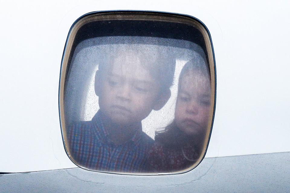 Princess Charlotte of Cambridge and Prince George of Cambridge look out of the window of the plane as they arrive at Warsaw airport during an official visit to Poland and Germany on July 17, 2017 in Warsaw, Poland.