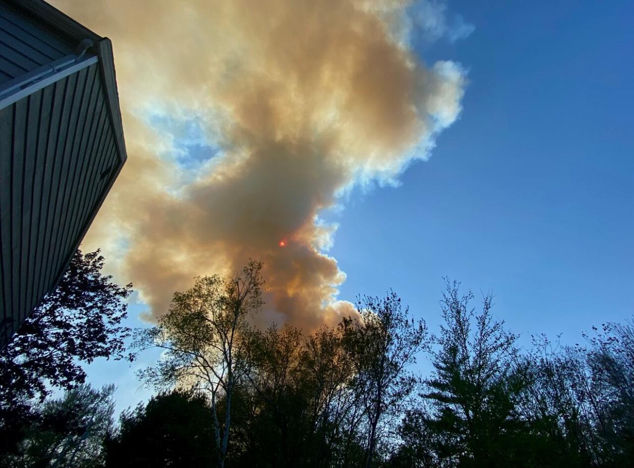 Smoke rises over Highland Park subdivision on the afternoon of May 28, 2023, moments before thousands of homes in that area were forced to evacuate due to a wildfire that broke out in nearby Westwood Hills. (Aly Thomson/CBC - image credit)