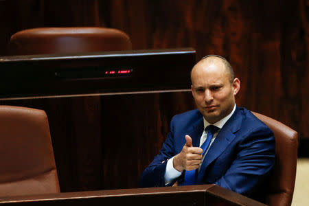 Israeli Education Minister Naftali Bennett gestures during a preliminary vote on a bill at the Knesset, the Israeli parliament, in Jerusalem November 16, 2016. REUTERS/Ammar Awad/File Photo