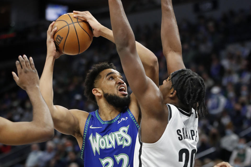 Minnesota Timberwolves center Karl-Anthony Towns (32) goes to the basket against Brooklyn Nets center Day'Ron Sharpe (20) in the first quarter of an NBA basketball game Sunday, Jan. 23, 2022, in Minneapolis. (AP Photo/Bruce Kluckhohn)