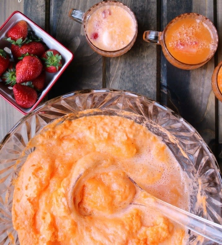 Creamsicle punch in a party punch bowl.