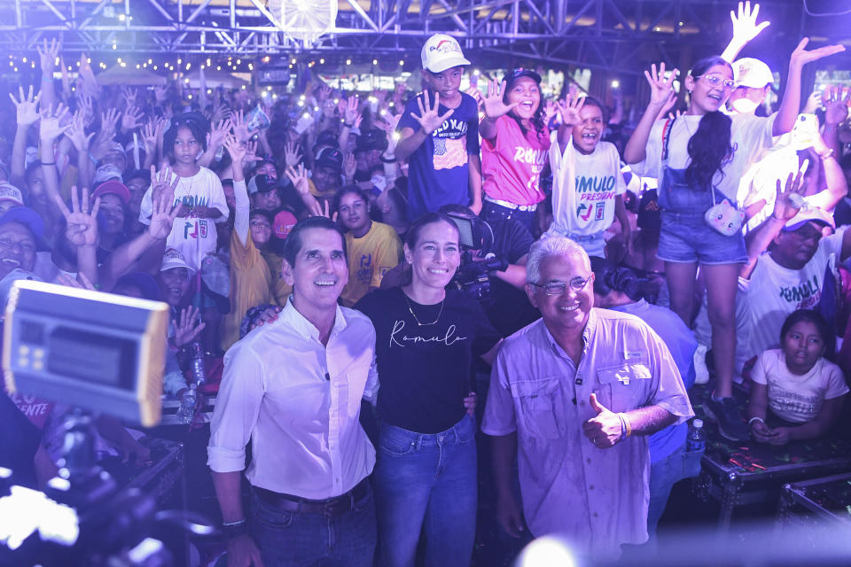 Romulo Roux, presidential candidate for Democratic Change, left, posses for a photo with his wife Victoria Heurtematte, center, and his vice-presidential ticket Jose Blanton during a closing campaign rally in Panama City, Sunday, April 28, 2024. Panama will hold general elections on May 5. (AP Photo/Agustin Herrera)