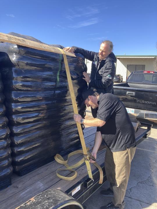 Chris Bane, left, and Chip Baker secure a pallet of soil to a trailer outside Baker's marijuana garden supply store, Tuesday, Feb. 28, 2023, in Oklahoma City. Voters in Oklahoma, which already has a robust medical marijuana program, will decide on Tuesday, March 7, whether to legalize cannabis for adults over the age of 21. (AP Photo by Sean Murphy)