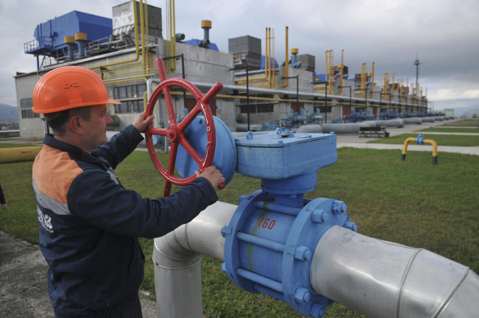 FILE - A worker at a Ukrainian gas station Volovets in western Ukraine Wednesday, Oct. 7, 2015. Europe's natural gas woes are far from over in Jan. 2022. Prices are high. Underground reserves that are relied on in cold weather are low. Russia's state-owned Gazprom isn't selling as much spot gas as it used to. The pipeline operators have told the European Union's executive commission that if there's a cold winter, the continent's gas companies will need to import more than they have in the past. (AP Photo/Pavlo Palamarchuk, File)