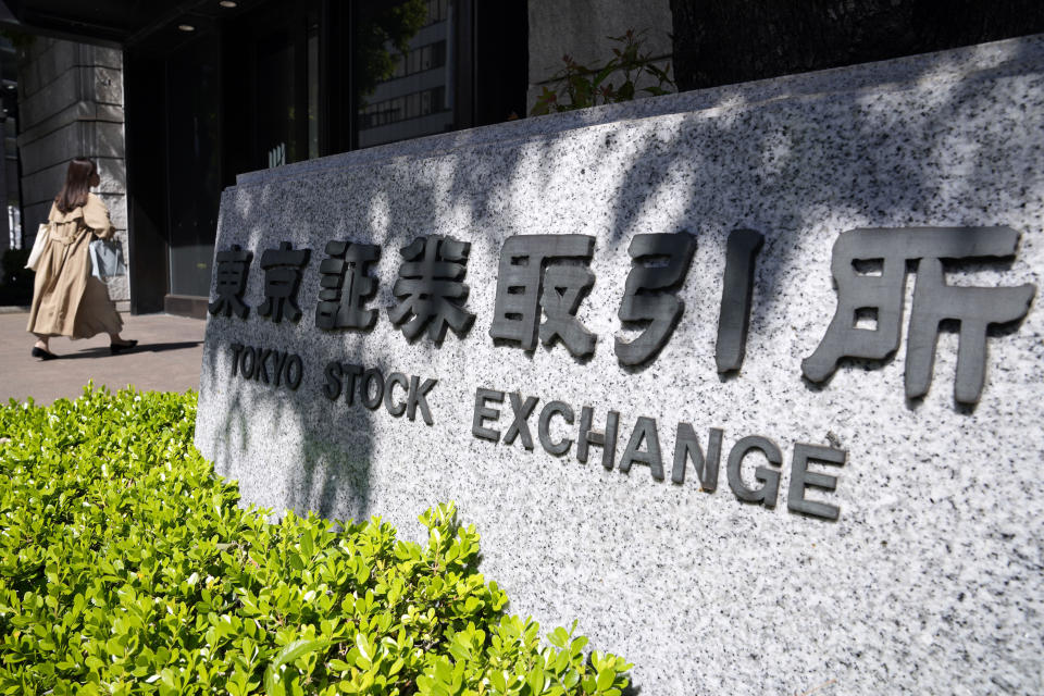 A person walks to Tokyo Stock Exchange building Thursday, April 27, 2023, in Tokyo. Shares advanced in Asia on Friday after Wall Street rallied to its best day since January. (AP Photo/Eugene Hoshiko)