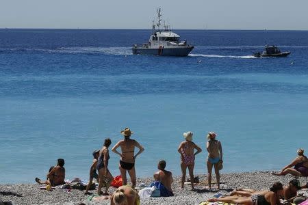 A French gendarme boat patrols waters near the beach two days after an attack by the driver of a heavy truck who ran into a crowd on Bastille Day killing scores and injuring as many on the Promenade des Anglais, in Nice, France, July 16, 2016. REUTERS/Pascal Rossignol