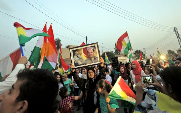 Kurds celebrate the independence referendum with a picture of Iraqi Kurdish leader Massud Barzani