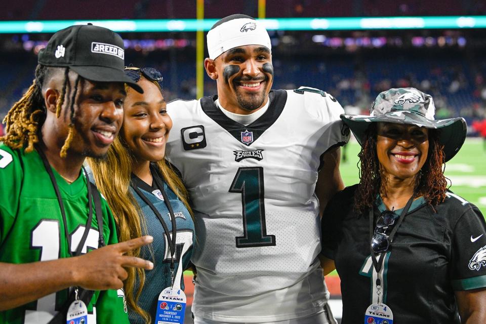 Philadelphia Eagles quarterback Jalen Hurts (1) takes a family portrait in the endzone with his brother, sister, and mother, before the football game between the Philadelphia Eagles and Houston Texans