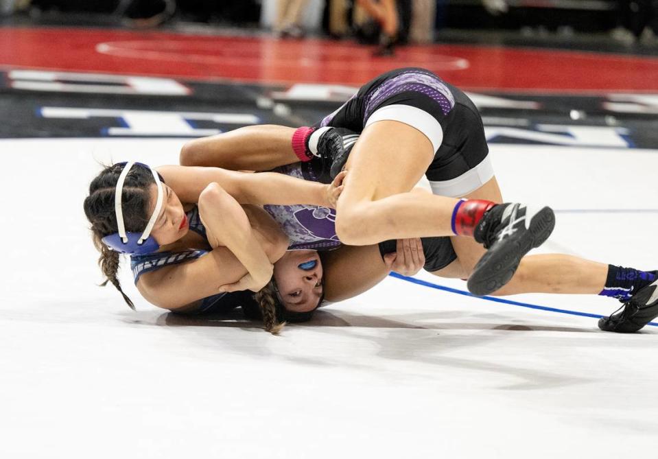 Central Catholic’s Jillian Wells locks up Giselle Solano of Franklin (Elk Grove) in the 100-pound title match during the Sac-Joaquin Section Masters Wrestling Championships at Stockton Arena in Stockton, Calif., Saturday, Feb. 17, 2024.