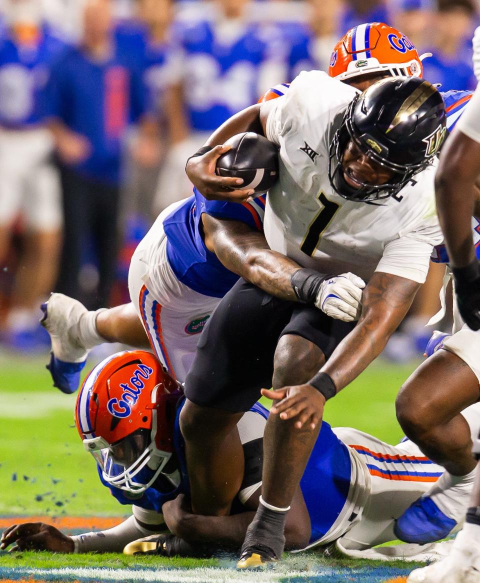 Florida Gators edge Justus Boone (1) sacks UCF Knights quarterback KJ Jefferson (1) during the first half at Ben Hill Griffin Stadium in Gainesville, FL on Saturday, October 5, 2024. [Doug Engle/Gainesville Sun]