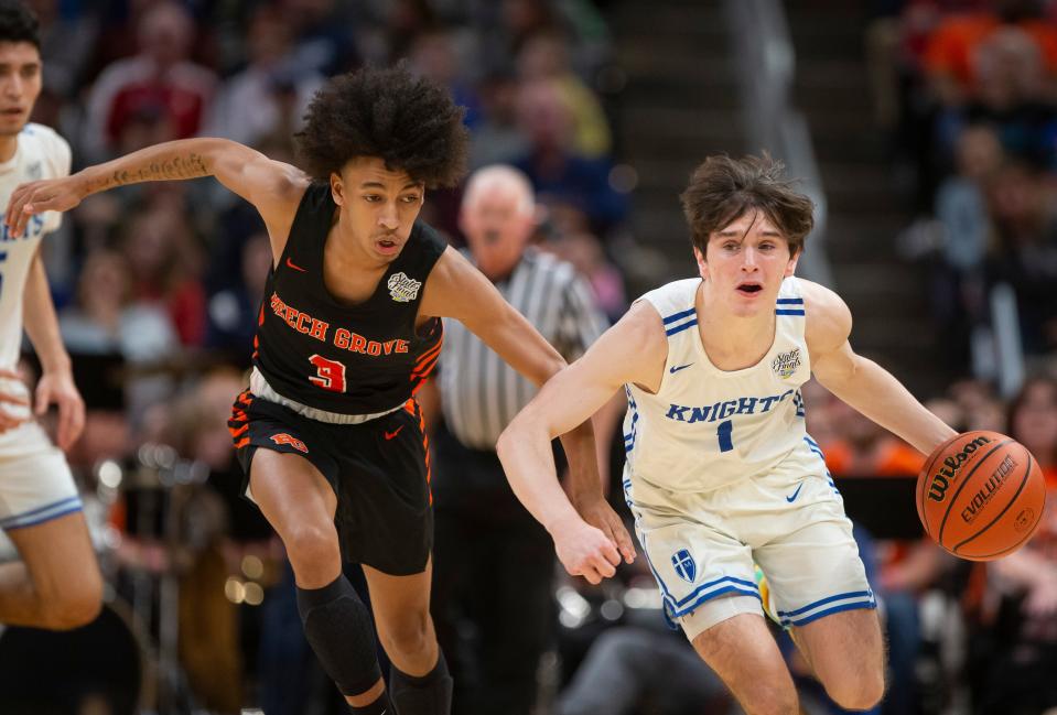 Marian's Deaglan Sullivan (1) drives downcourt next to Beech Grove's Adrian Holland (3) during the 3A boys basketball state championship game on Saturday, March 26, 2022, at Gainbridge Fieldhouse in Indianapolis. 