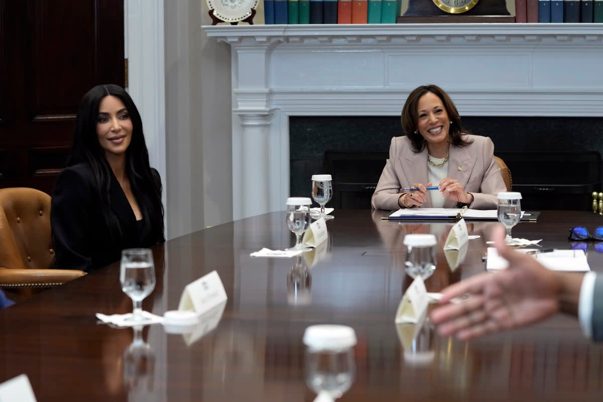 Vice President Kamala Harris and Kim Kardashian listen during a discussion in the Roosevelt Room of the White House in Washington on 25 April 2024 (AP)