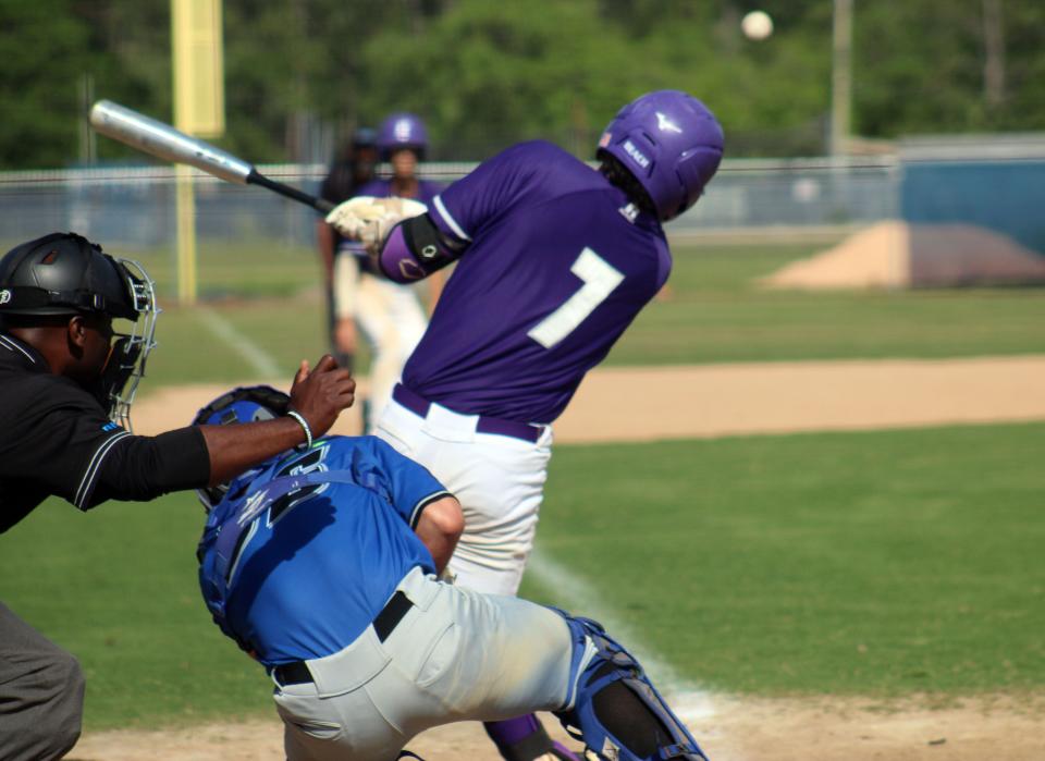 Fletcher's Angel Oquendo hits the ball during a Gateway Conference high school baseball semifinal against First Coast on April 21, 2022. The ball curved foul, but Oquendo singled in a run later in the same at-bat. [Clayton Freeman/Florida Times-Union]