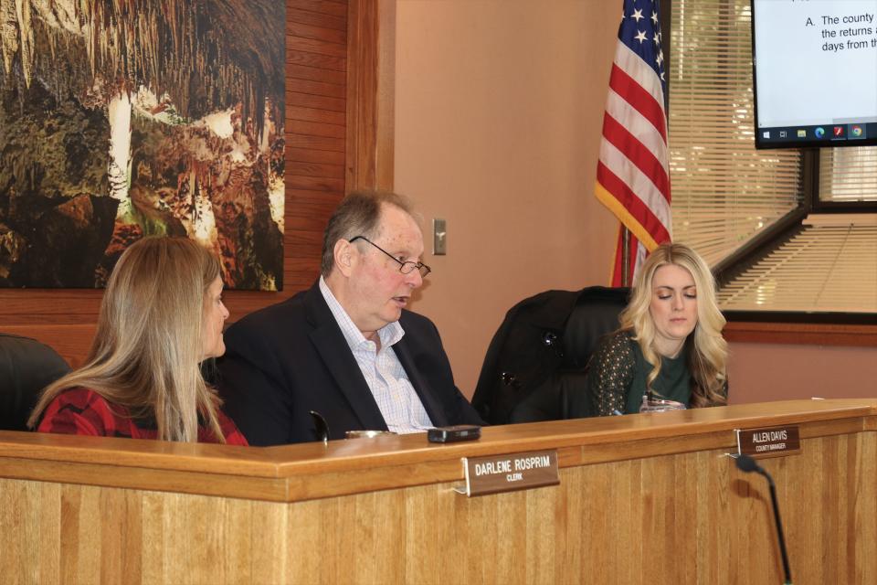 Eddy County Manager Allen Davis talks about Eddy County's election process as Eddy County Clerk Darlene Rosprim (left) and District 5 Eddy County Commissioner Sarah Cordova (right) listen.