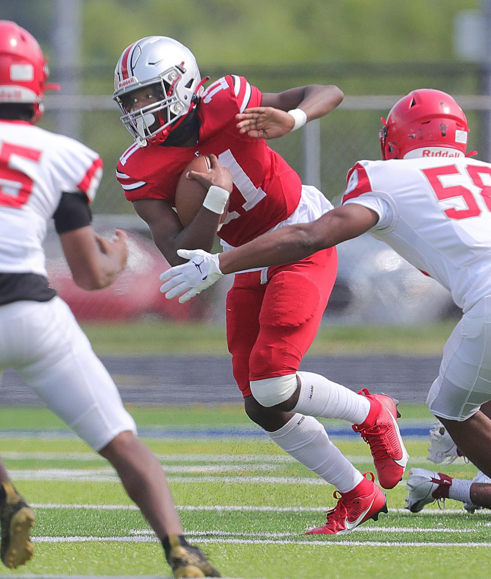 East quarterback Marlin Engram runs against Youngstown Chaney on Friday in Akron.