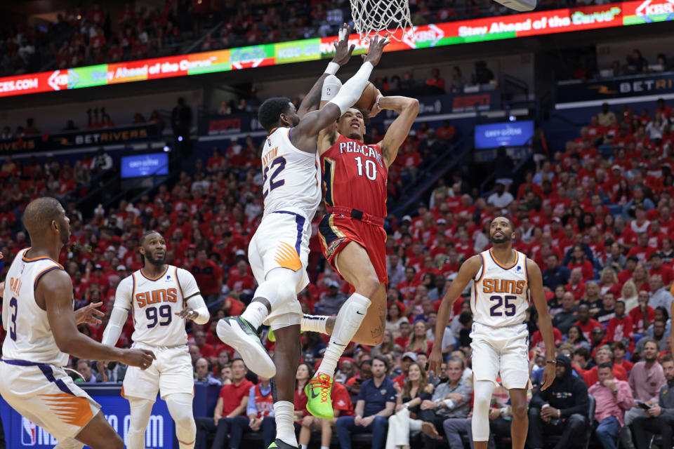 New Orleans Pelicans center Jaxson Hayes (10) is fouled by Phoenix Suns center Deandre Ayton (22) during the first half of Game 3 of an NBA basketball first-round playoff series in New Orleans, Friday, April 22, 2022. (AP Photo/Michael DeMocker)