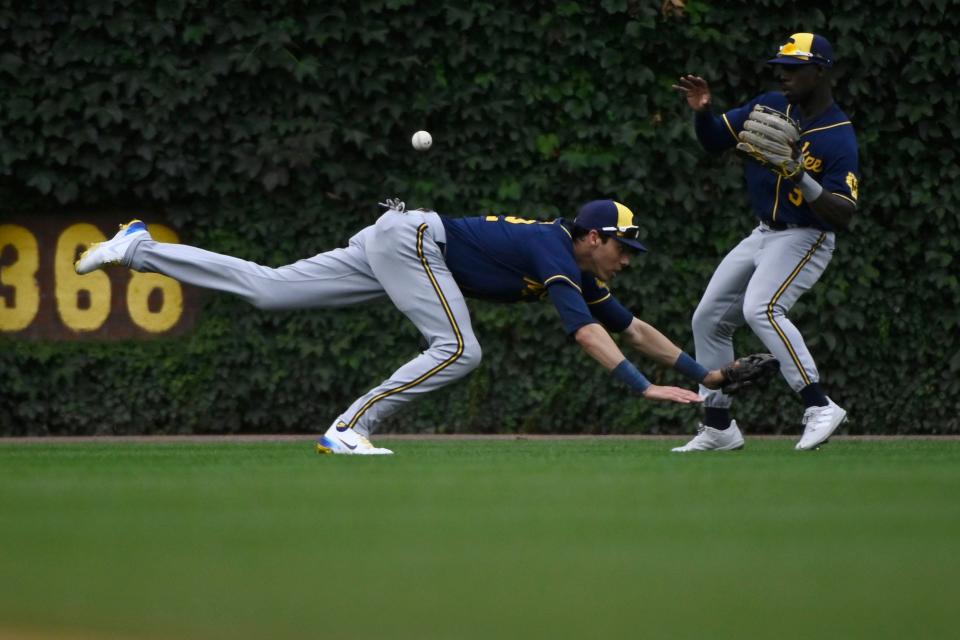 Brewers left fielder Christian Yelich is unable to catch the fly ball  off the bat of the Cubs' Seiya Suzuki during the fourth inning Saturday.